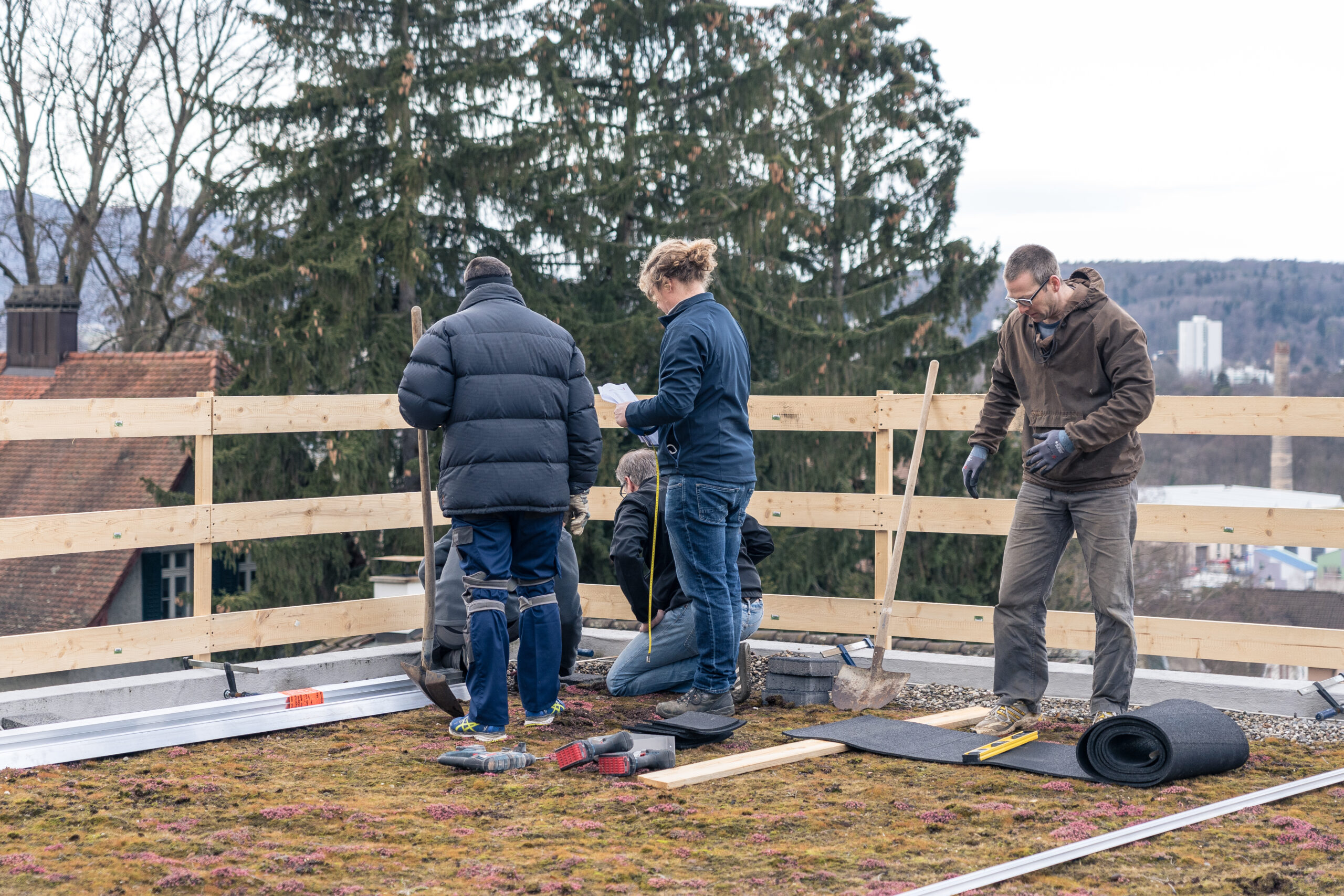 Gruppe auf einem Flachdach, bei der Montage einer Solaranlage
